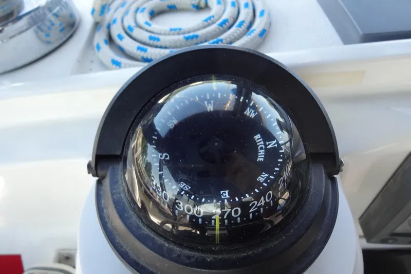Slide: The Image of Compass on 1996 Lagoon 35 CCC yacht, with coiled rope in background. - 81