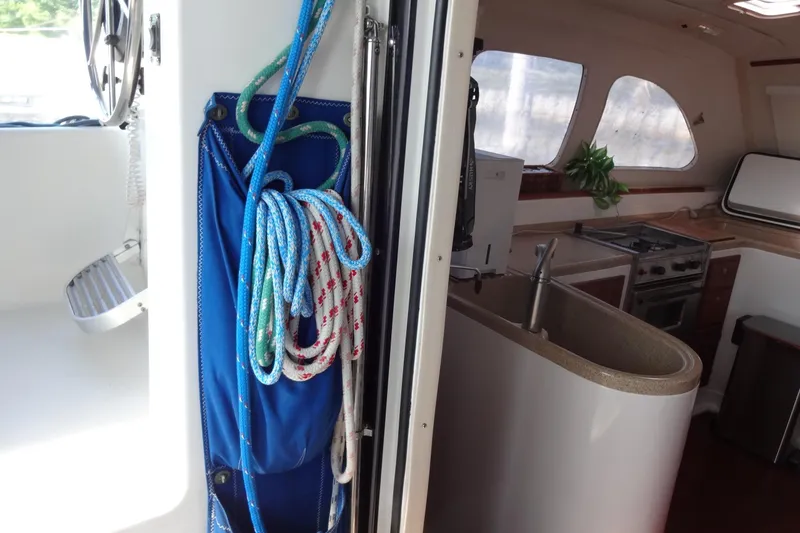 Slide: The Image of Interior of 1996 Lagoon 35 CCC yacht showing kitchen and coiled ropes. - 85