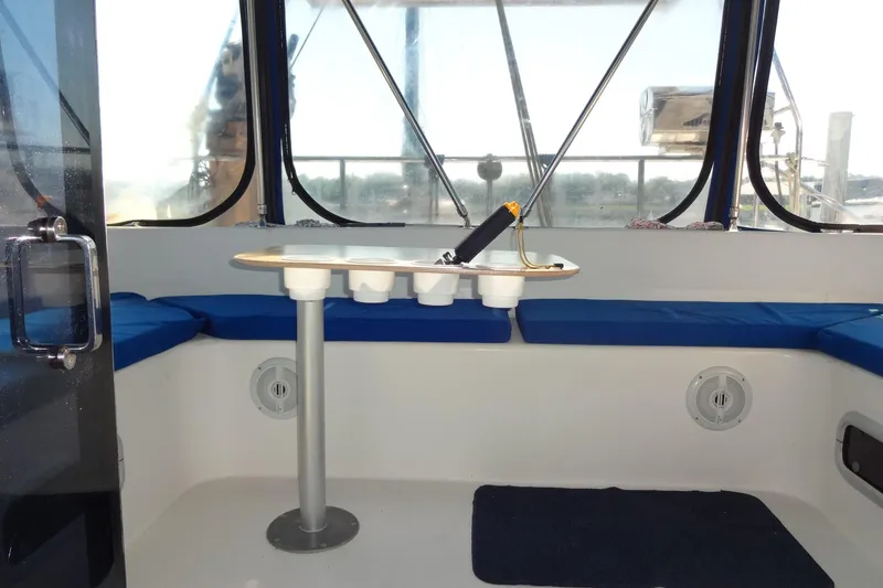 Slide: The Image of Interior of 1996 Lagoon 35 CCC boat with blue seating and table. - 88