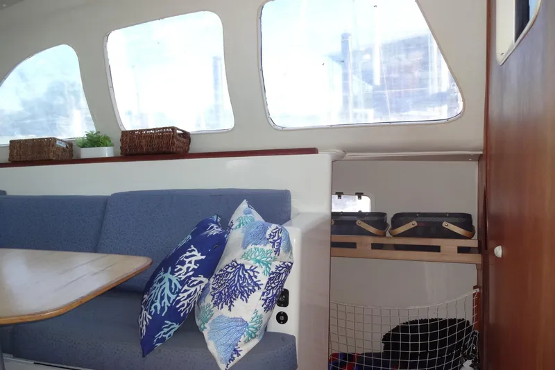 Slide: The Image of Interior of 1996 Lagoon 35 CCC yacht with blue seating and decorative pillows. - 91
