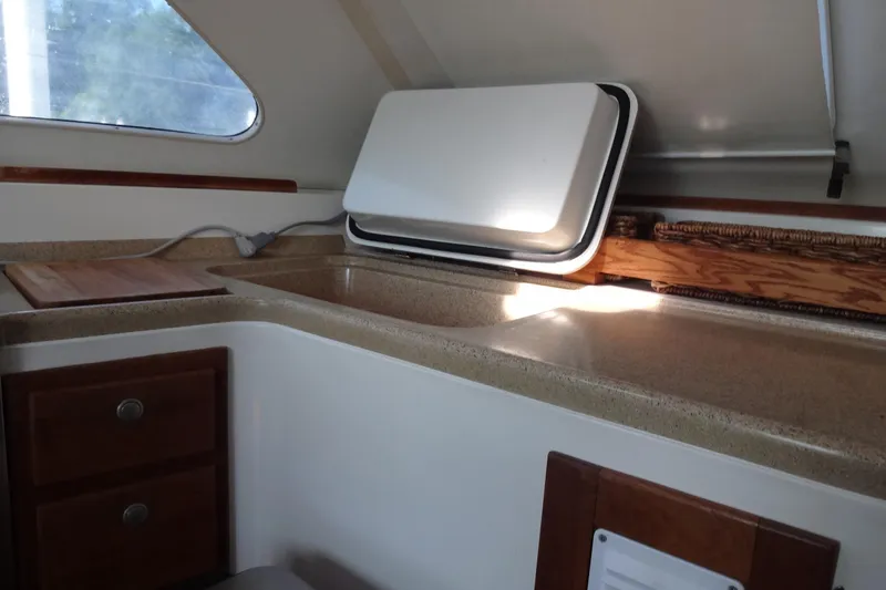 Slide: The Image of Interior view of 1996 Lagoon 35 CCC yacht kitchen with countertop and storage. - 94