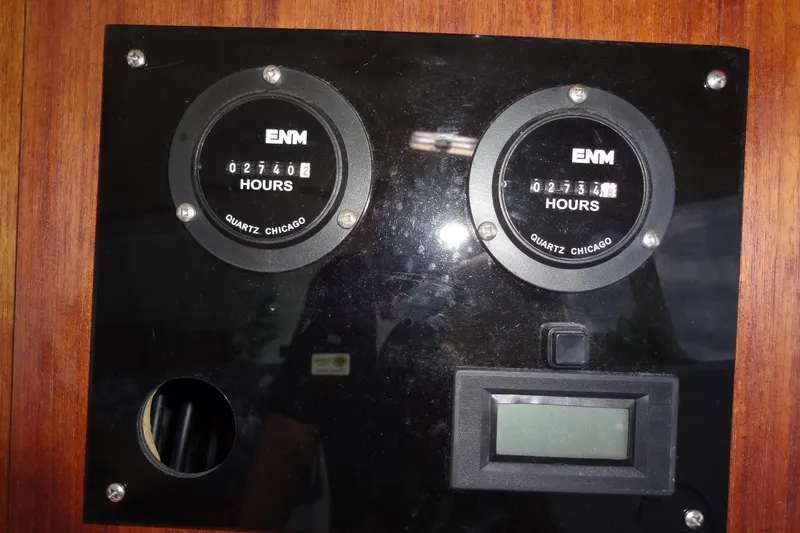 Slide: The Image of Hour meters on a 1996 Lagoon 35 CCC yacht dashboard, displaying engine hours. - 99