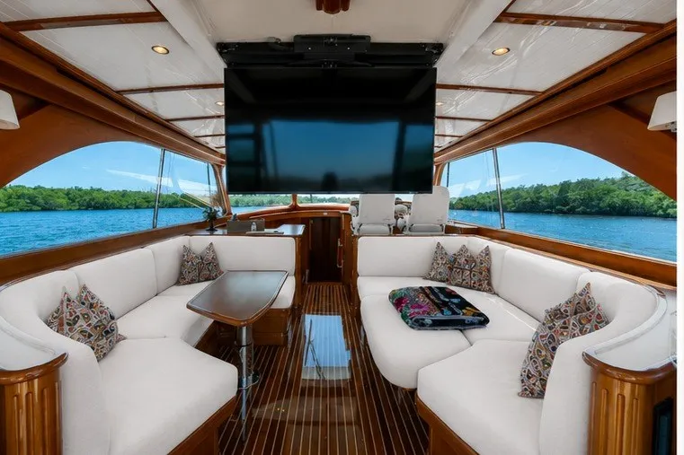 Slide: The Image of Luxurious interior of 2021 Hinckley Talaria 55 Flybridge MKII yacht with plush seating and large TV. - 26