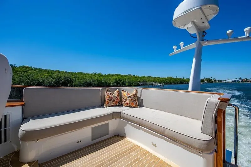 Slide: The Image of Hinckley Talaria 55 Flybridge MKII 2021 yacht with elegant outdoor seating and scenic water view. - 19