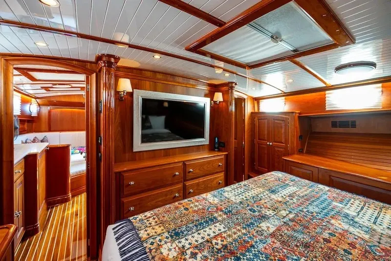 Slide: The Image of Luxurious 2021 Hinckley Talaria 55 Flybridge MKII yacht interior with elegant wood finish and cozy bedroom. - 32
