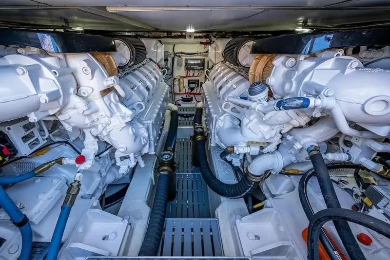 Slide: The Image of Engine room of 2021 Hinckley Talaria 55 Flybridge MKII, showcasing dual powerful engines. - 14