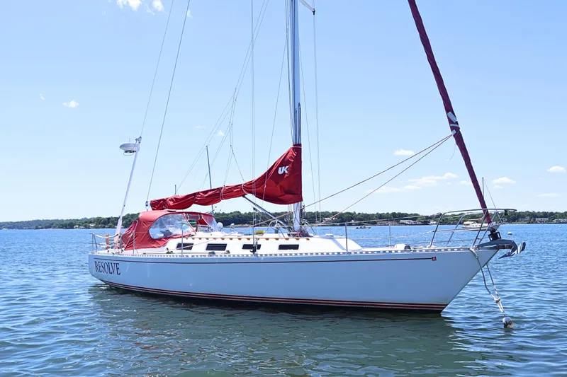 The Image of 1989 J Boat J 40 sailboat with red sails on calm water. - 0