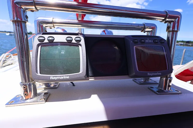 Slide: The Image of Raymarine navigation instruments on a 1989 J Boat J 40, with a scenic water backdrop. - 11
