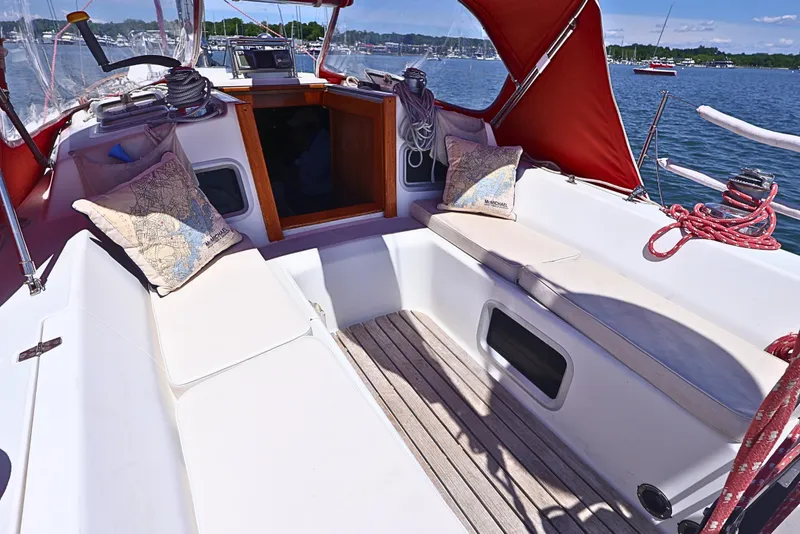 Slide: The Image of Cockpit of 1989 J Boat J 40 sailboat with red canopy and comfortable seating. - 13