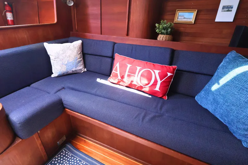 Slide: The Image of Cozy interior of 1989 J Boat J 40 with nautical-themed cushions and wooden paneling. - 22