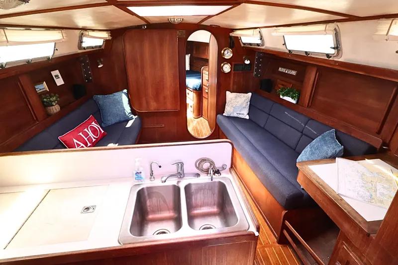 Slide: The Image of Interior of 1989 J Boat J 40 sailboat with cozy seating and wooden finishes. - 24