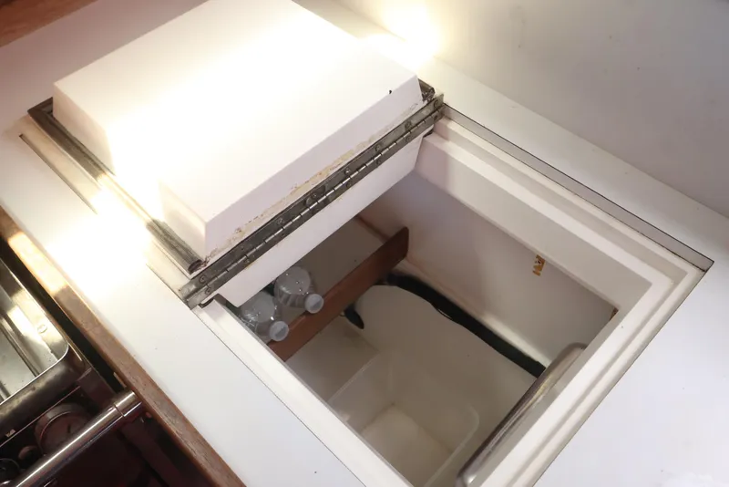 Slide: The Image of Interior view of a 1989 J Boat J 40, featuring a built-in storage compartment. - 26