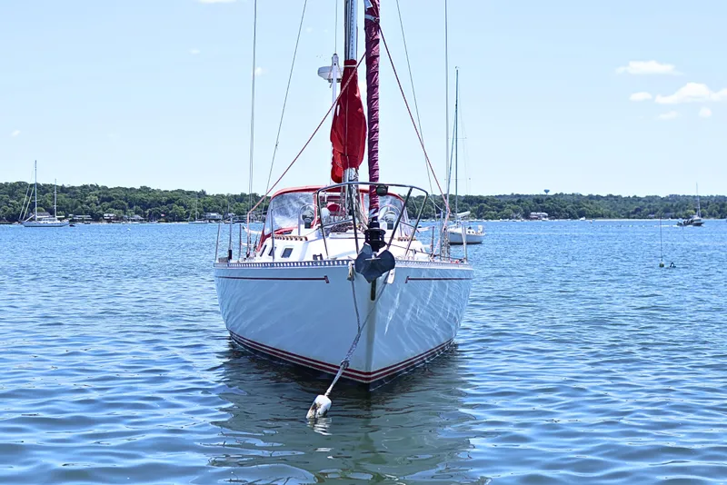 Slide: The Image of 1989 J Boat J 40 sailboat anchored on calm blue water. - 3