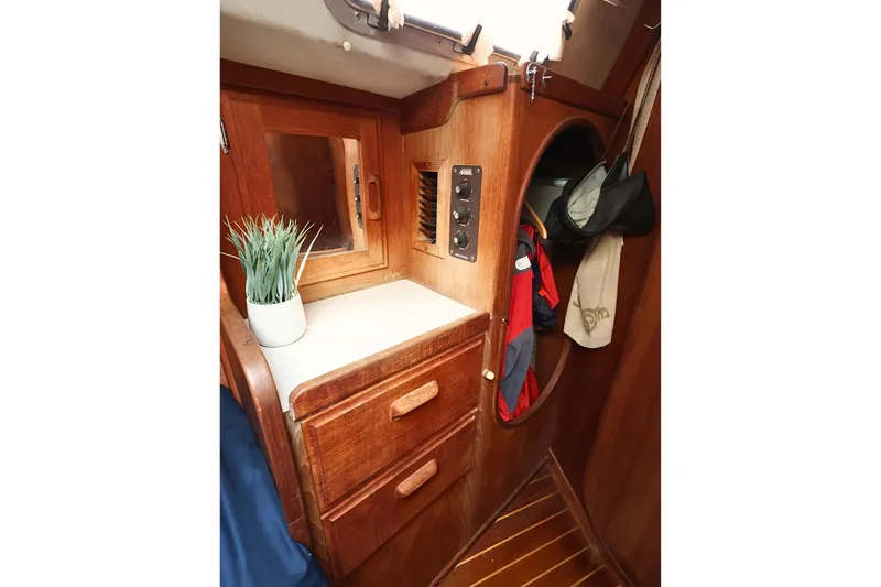 Slide: The Image of Interior of 1989 J Boat J 40, featuring wooden cabinetry and storage space. - 30