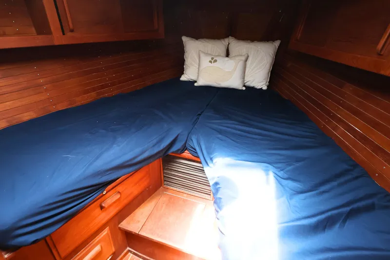 Slide: The Image of Cozy cabin interior of 1989 J Boat J 40 with blue bedding and wooden finish. - 31
