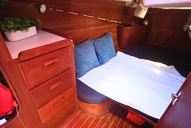 Slide: The Image of Cozy cabin interior of 1989 J Boat J 40 with wooden drawers and bedding. - 32
