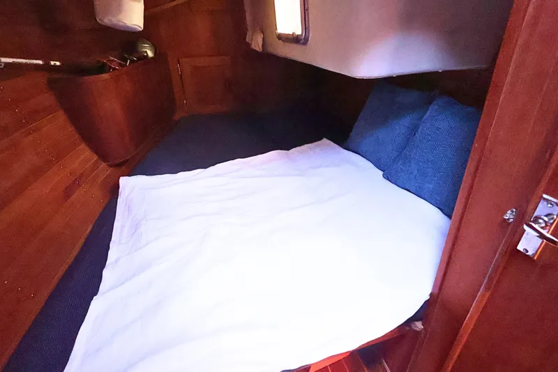 Slide: The Image of Cozy cabin interior of 1989 J Boat J 40 with wooden finish and bedding. - 33