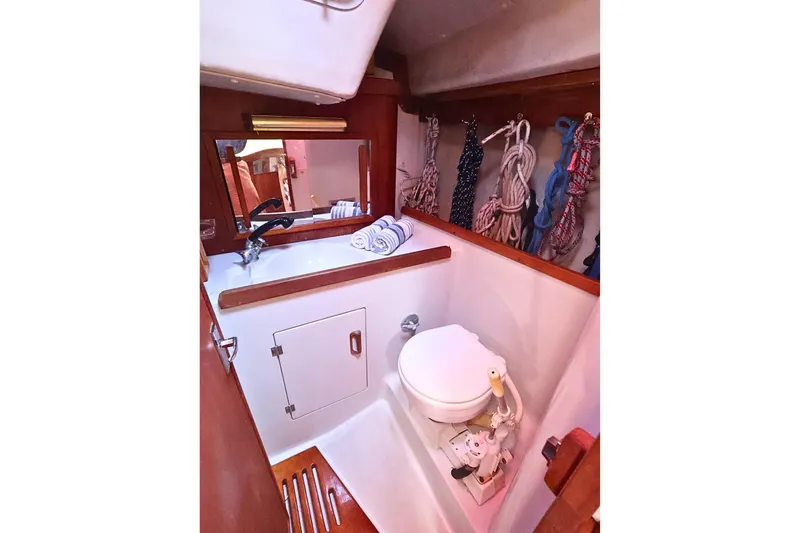 Slide: The Image of 1989 J Boat J 40 yacht bathroom with sink, mirror, and marine toilet. - 34