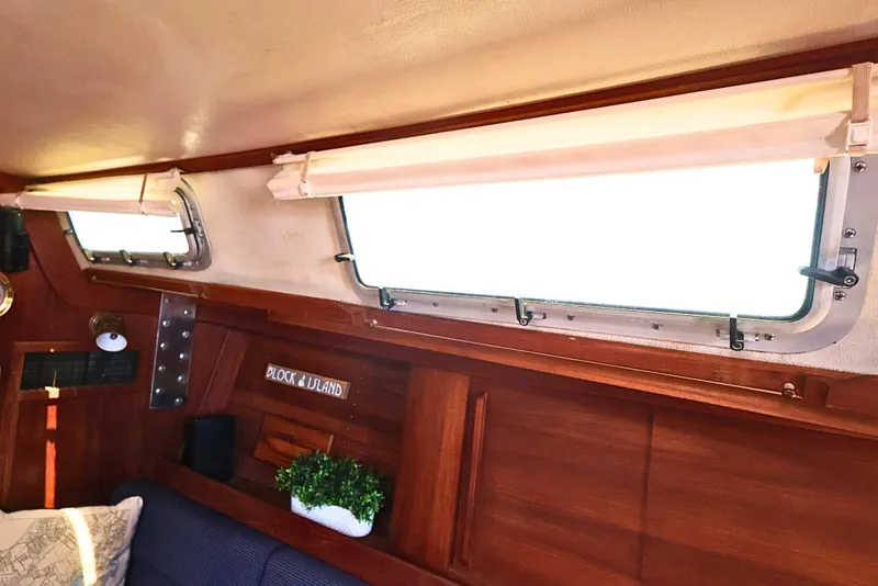 Slide: The Image of Interior of 1989 J Boat J 40 with wooden paneling and porthole windows. - 36