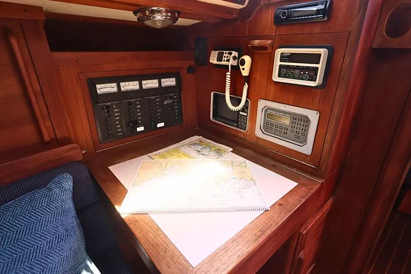 Slide: The Image of Navigation station on a 1989 J Boat J 40, featuring charts and control panels. - 38