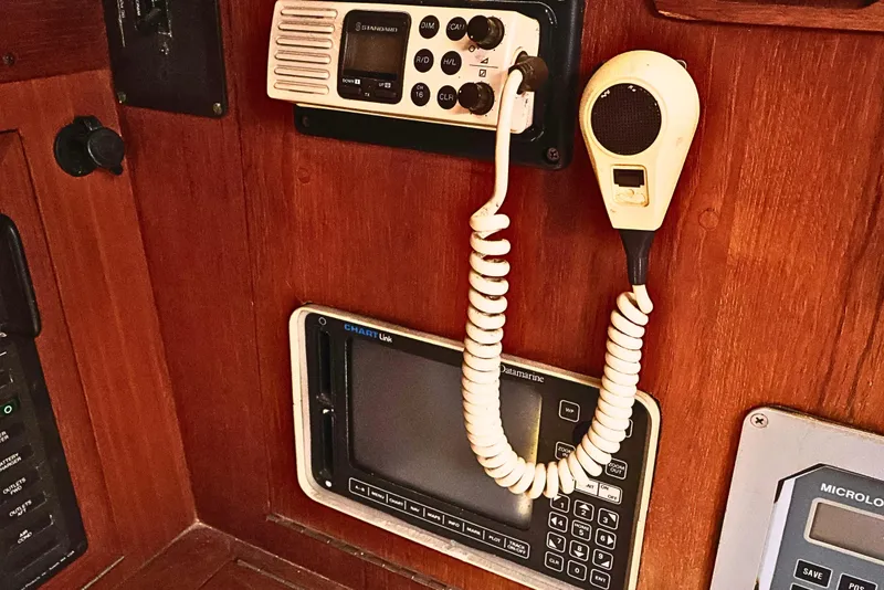 Slide: The Image of 1989 J Boat J 40 navigation equipment with radio and control panel on wooden interior. - 41