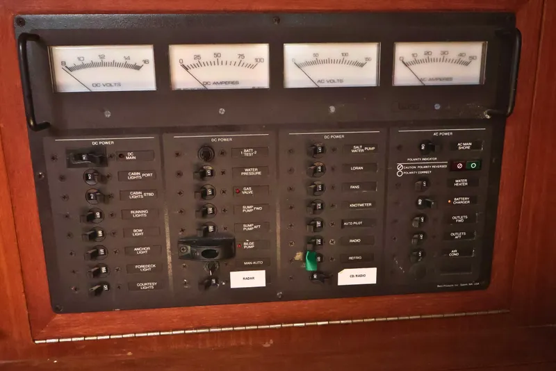 Slide: The Image of Electrical control panel on a 1989 J Boat J 40, featuring voltage and amperage gauges. - 42