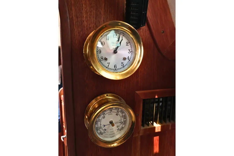 Slide: The Image of Brass clock and barometer on 1989 J Boat J 40 wooden interior. - 44