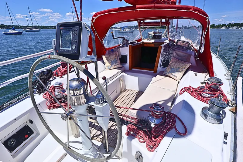 Slide: The Image of Cockpit of 1989 J Boat J 40 sailboat with red canopy and navigation equipment. - 8