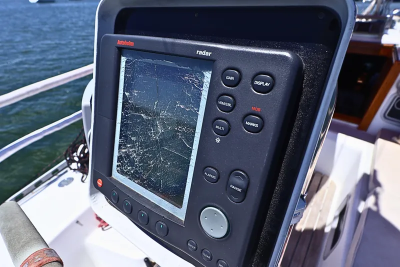 Slide: The Image of Cracked radar screen on 1989 J Boat J 40, displaying damaged navigation equipment. - 9