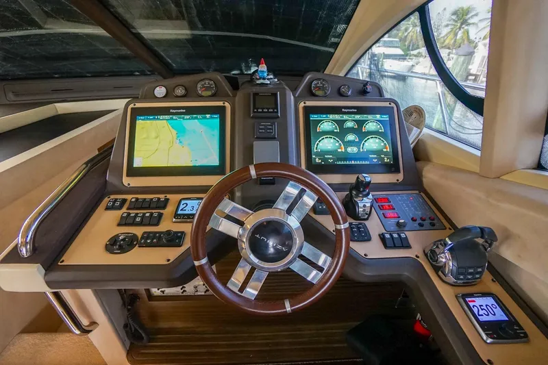 Slide: The Image of 2014 Azimut 54 Flybridge yacht helm with advanced navigation displays and controls. - 34