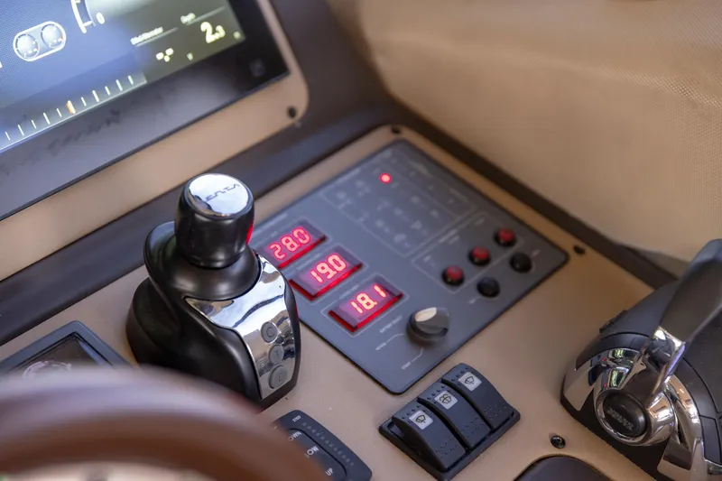Slide: The Image of Control panel of a 2014 Azimut 54 Flybridge yacht, featuring digital displays and controls. - 49