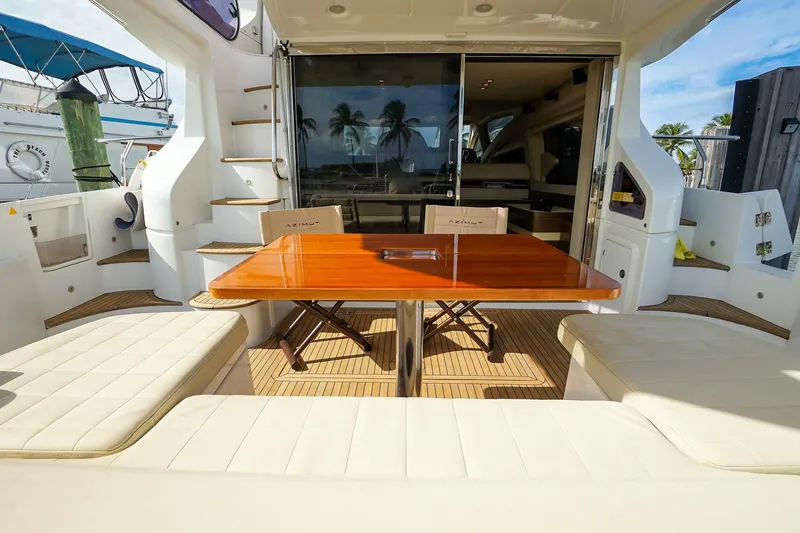 Slide: The Image of Luxurious 2014 Azimut 54 Flybridge yacht interior with elegant seating and wooden table. - 63