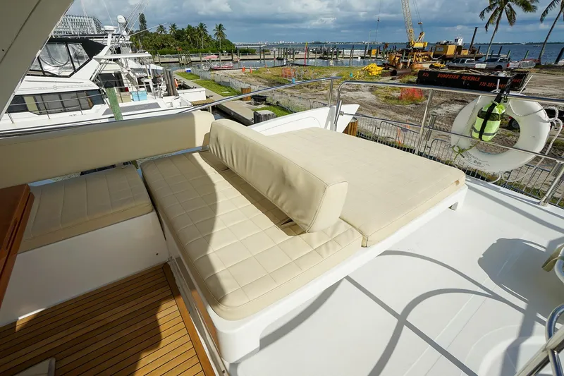 Slide: The Image of Luxurious seating area on 2014 Azimut 54 Flybridge yacht with scenic marina view. - 68