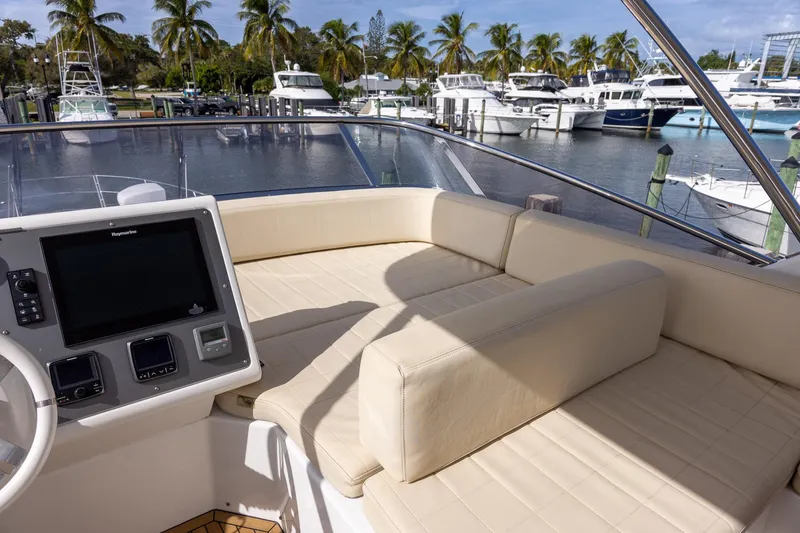 Slide: The Image of Flybridge of 2014 Azimut 54 yacht with beige seating, docked at marina with palm trees. - 75
