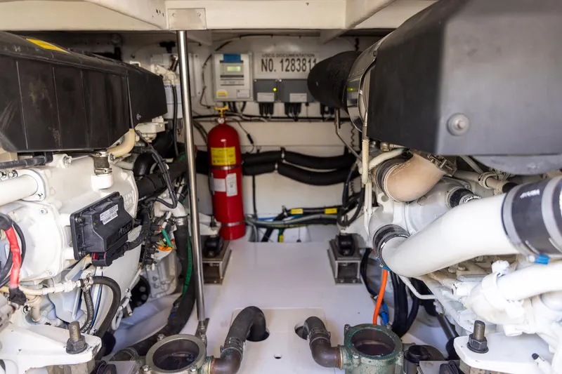 Slide: The Image of Engine room of 2014 Azimut 54 Flybridge yacht, featuring dual engines and safety equipment. - 88