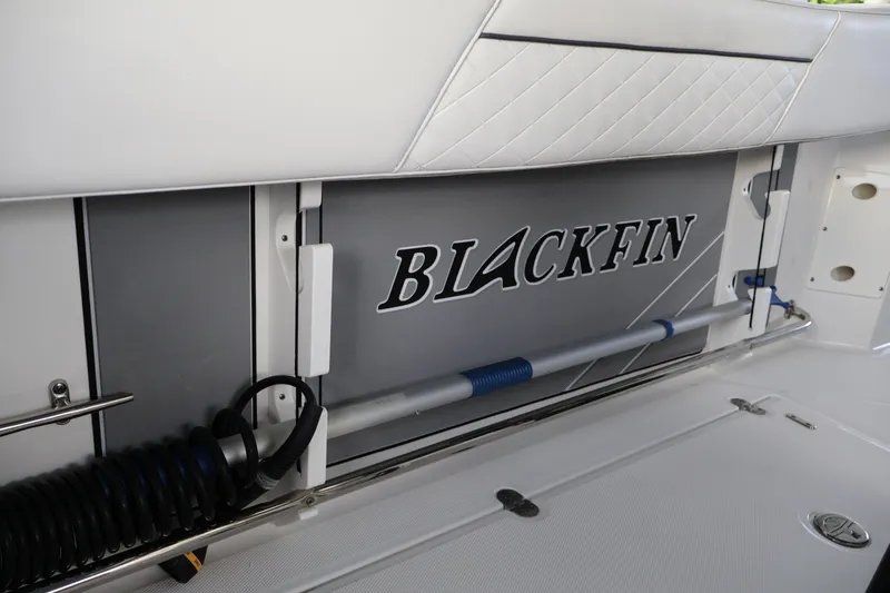 Slide: The Image of 2021 Blackfin 272 CC boat interior detail with logo and storage compartment. - 21