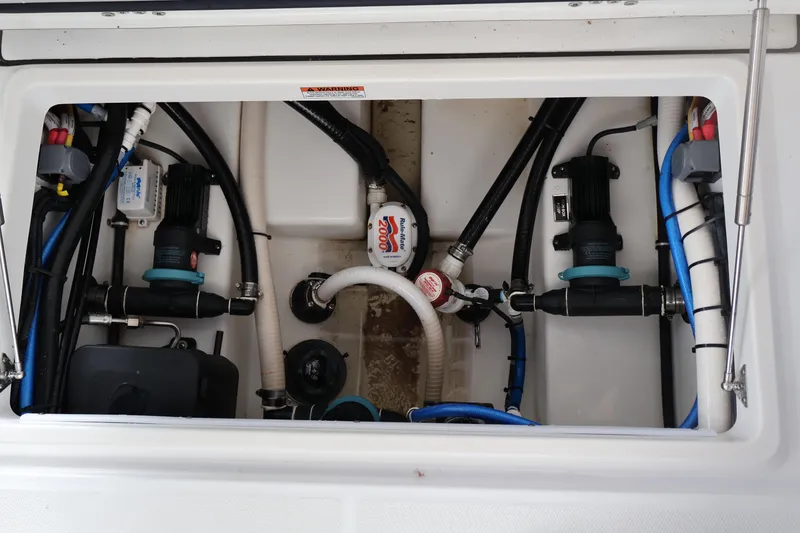 Slide: The Image of 2021 Blackfin 272 CC boat plumbing system with pumps and hoses. - 26