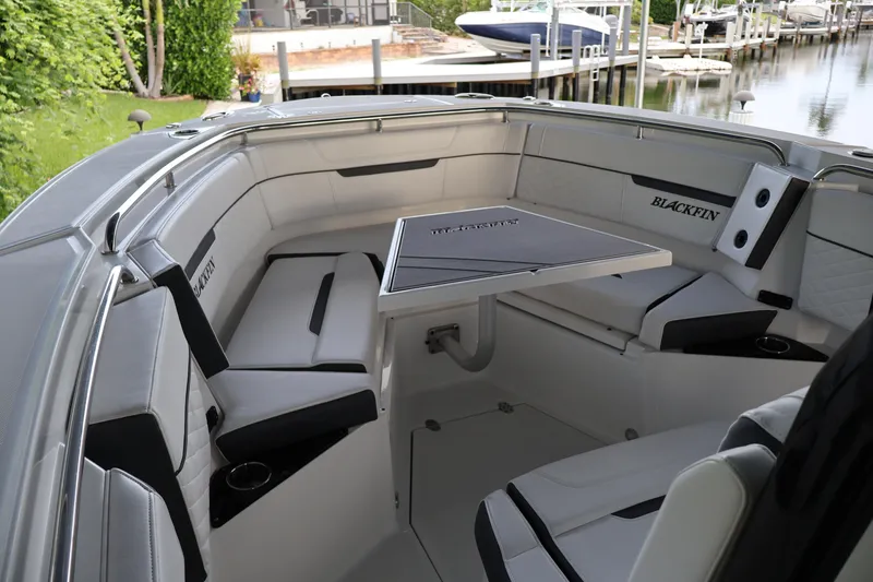 Slide: The Image of Luxurious seating area on a 2021 Blackfin 272 CC boat, featuring a central table. - 28