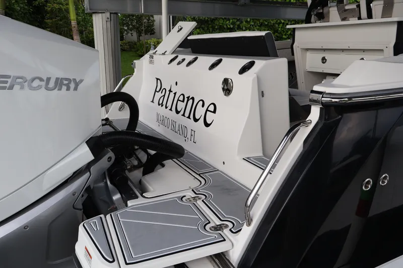 Slide: The Image of 2021 Blackfin 272 CC boat with Mercury engine, named "Patience," docked at Marco Island, FL. - 4