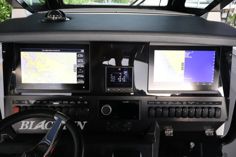 Slide: The Image of 2021 Blackfin 272 CC dashboard with navigation screens and controls. - 6