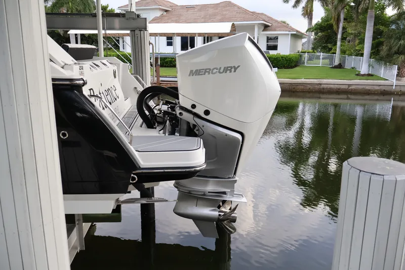 Slide: The Image of 2021 Blackfin 272 CC boat with Mercury outboard engine docked by waterfront home. - 8