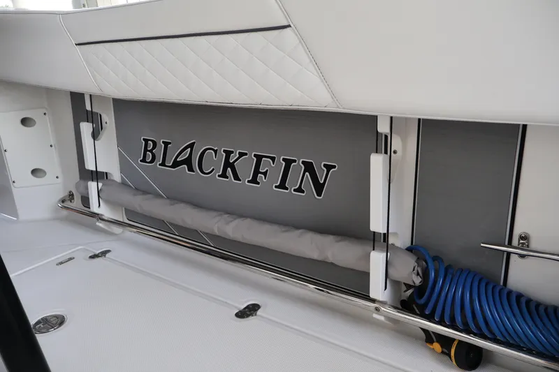 Slide: The Image of 2021 Blackfin 272 CC boat interior with logo and coiled blue hose. - 20