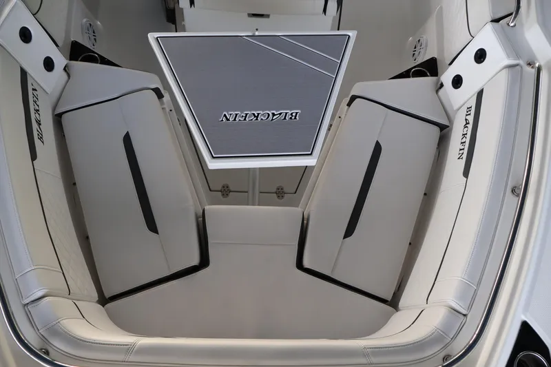 Slide: The Image of 2021 Blackfin 272 CC boat interior with cushioned seating and branded table. - 31
