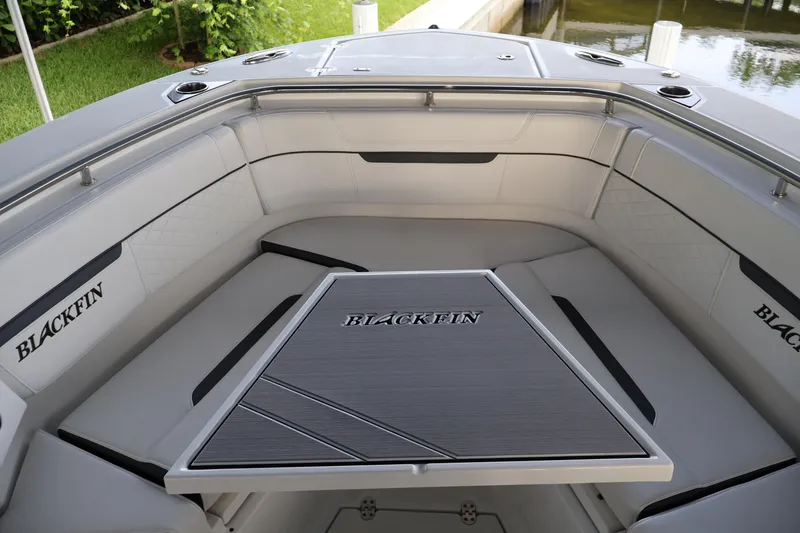 Slide: The Image of 2021 Blackfin 272 CC boat interior with cushioned seating and table. - 32