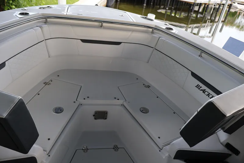 Slide: The Image of Interior of 2021 Blackfin 272 CC boat, featuring spacious seating and storage compartments. - 40