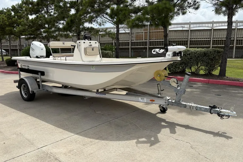 Slide: The Image of 2024 Carolina Skiff E18 JVX CC boat on trailer, parked outdoors. - 1