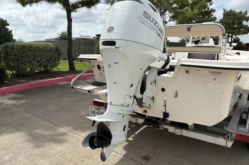 Slide: The Image of 2024 Carolina Skiff E18 JVX CC with Suzuki outboard motor on trailer. - 3