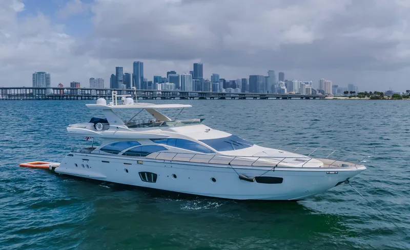 The Image of 2008 Azimut Flybridge yacht cruising near city skyline on a cloudy day. - 0