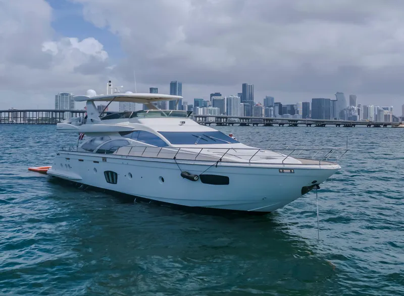 Slide: The Image of 2008 Azimut Flybridge yacht on water with city skyline in background. - 2
