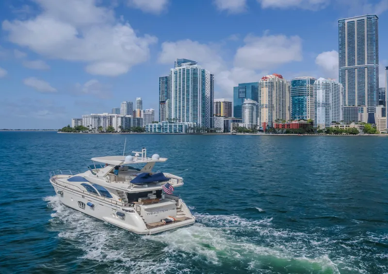 Slide: The Image of Azimut Flybridge 2008 yacht cruising near a city skyline on a sunny day. - 27